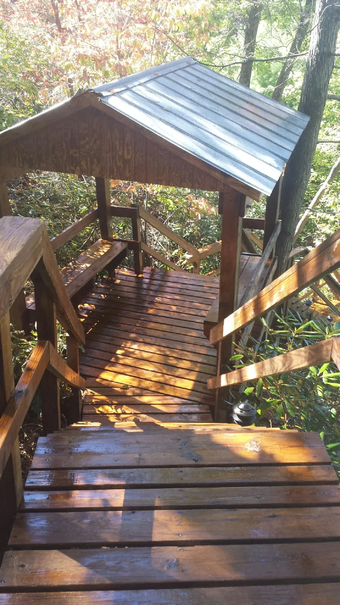 Freshly stained wood walkway and covered shelter with a metal roof in Negley
