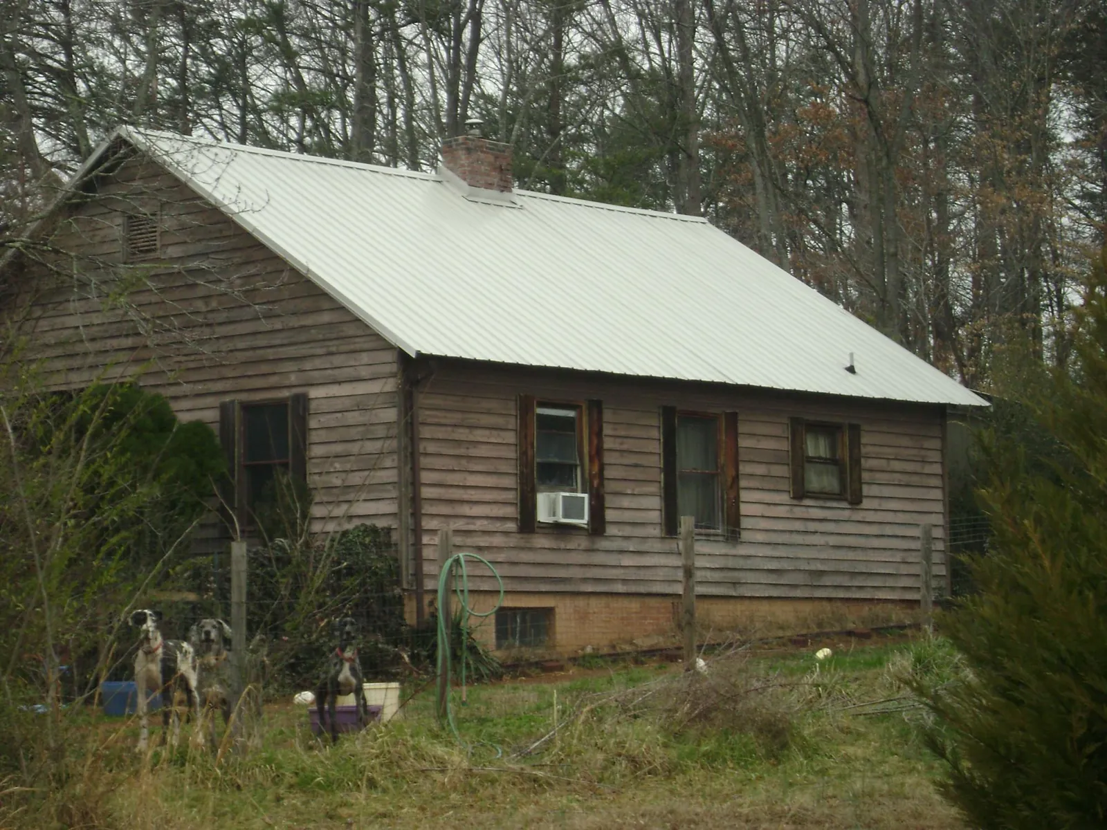 White metal roof on an old wood sided farmhouse, from a Metal Roof Installation job in Negley